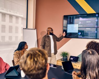 Multiracial business team in a meeting with data analysis presentation in a modern office. Corporate strategy and analytics concept